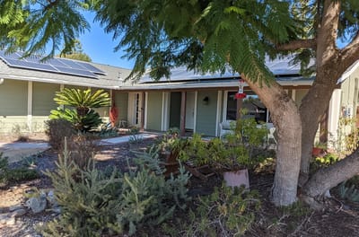 Exterior view of a residential senior living facility with landscaped garden
