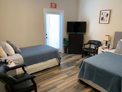 Private room with two beds and a TV
