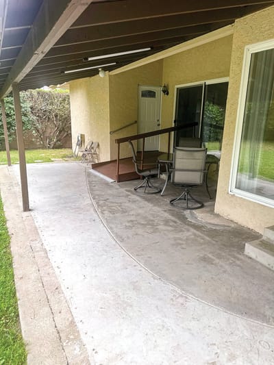 Outdoor patio area with chairs and a ramp