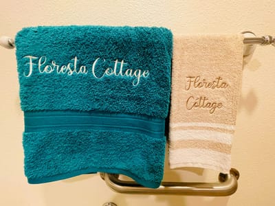 Towels with Floresta Cottage branding on display