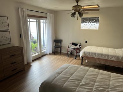 A light-filled shared resident room with two beds