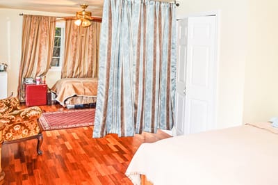 Private resident room with decorative curtains and wooden flooring