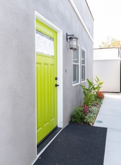 Bright green door of a facility with plants