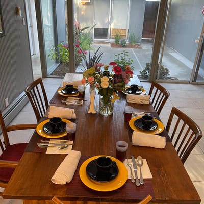 Dining table set for a meal with flowers and decor