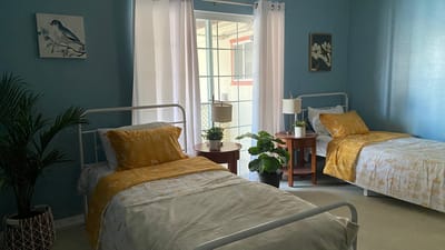 Two twin beds in a bright, airy room