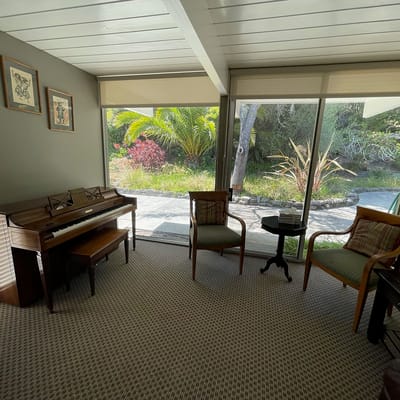 Bright interior space with seating and piano