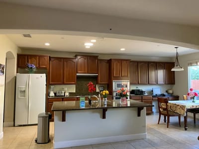 Bright kitchen area with wooden cabinets and dining space