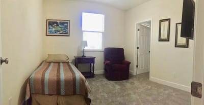 Private resident room with a bed and chair