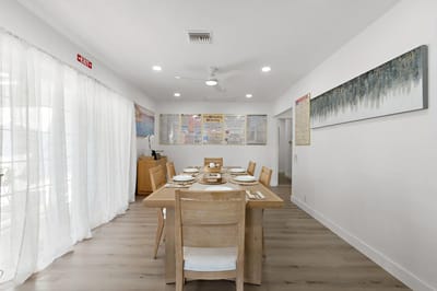 Bright dining area with wooden tables and chairs