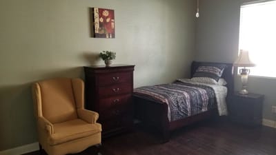 Cozy private resident room with bed and chair