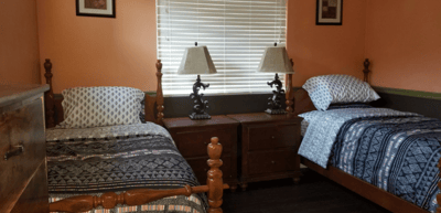 Cozy bedroom with two beds and lamps