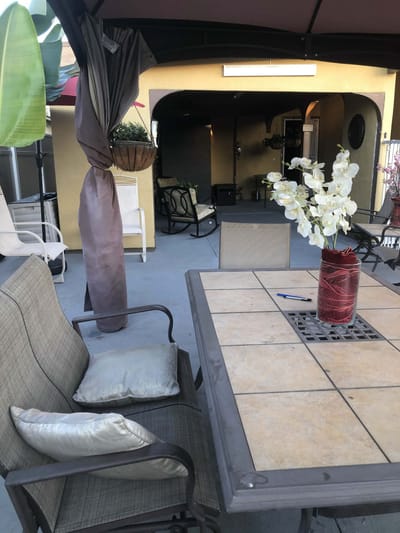 Outdoor seating area with a table and decorative vase