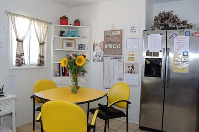 Bright kitchen area with a table and chairs