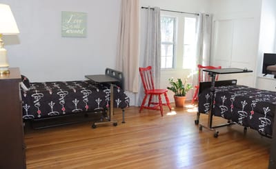 Resident room with two adjustable beds and natural light