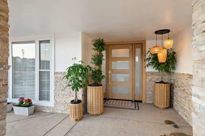 Entrance of a facility with decorative plants and lighting