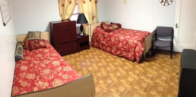 A shared room in a senior living facility with two beds
