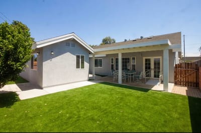 Outdoor space with a well-maintained lawn and patio area