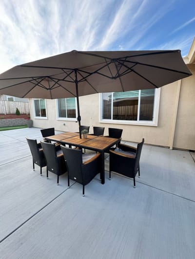 Outdoor dining area with seating and umbrella