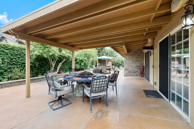 Outdoor patio area with seating and greenery
