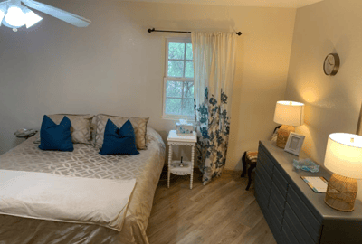 Cozy interior of a resident room with a bed and decor