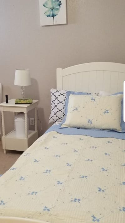 Cozy resident room with a bed and bedside table