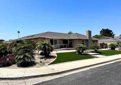Exterior view of a senior living facility with landscaping