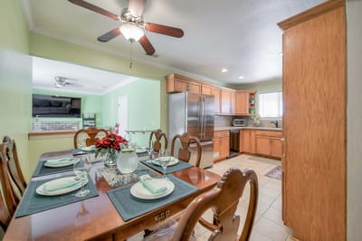 Dining room set for a meal with a table and kitchen