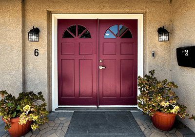 Exterior view of a facility entrance with purple doors