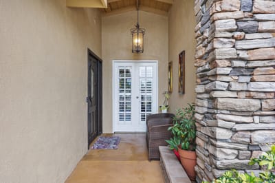 Welcoming entrance with stone accents and plants