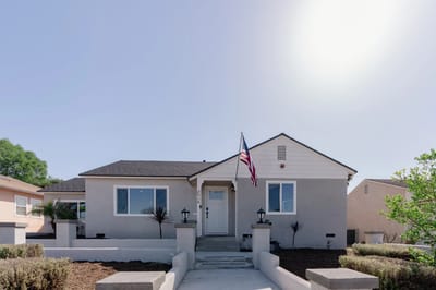 Exterior view of a residential care facility with a flag