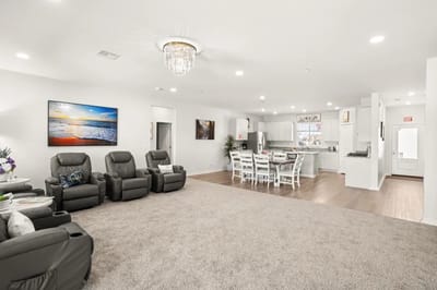 Bright common area with seating and kitchen access