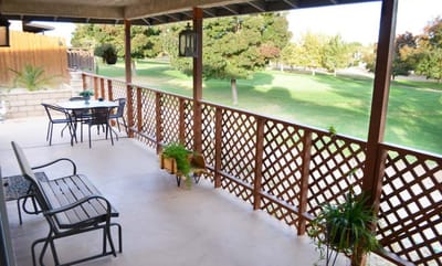 Outdoor patio area with seating and view of greenery