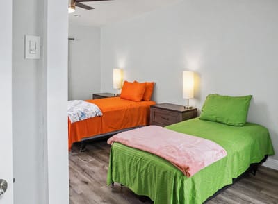 Brightly decorated shared resident room with two beds