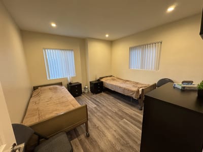 Private resident room with two beds and furniture
