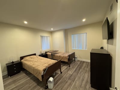 Private resident room with two beds and minimal decor