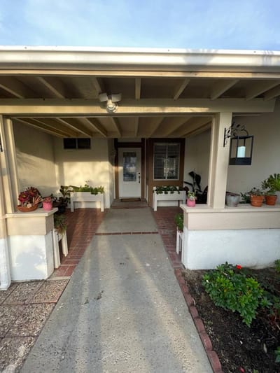Front entrance of Hany's Guest Home with potted plants