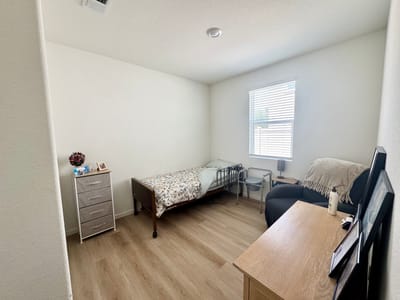 Private resident room with bed and chair