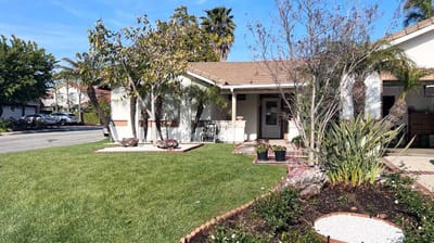 Exterior view of Hany's Guest Home with landscaping