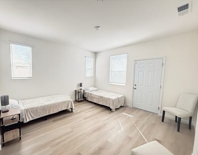 A simple interior view of a resident room with two beds