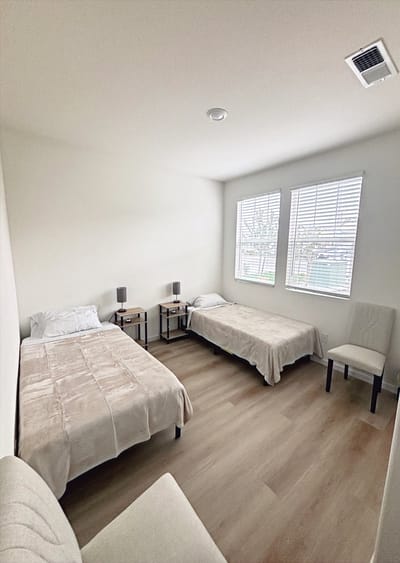 Bright, clean resident room with two beds