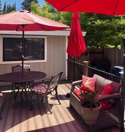 Outdoor seating area with red umbrellas and furniture