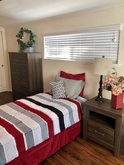 Cozy private resident room with bed and dresser