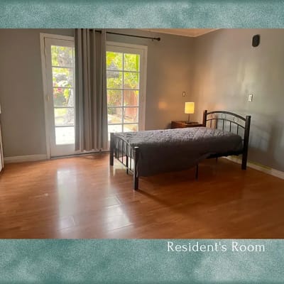 Bright resident's room with a bed and patio door