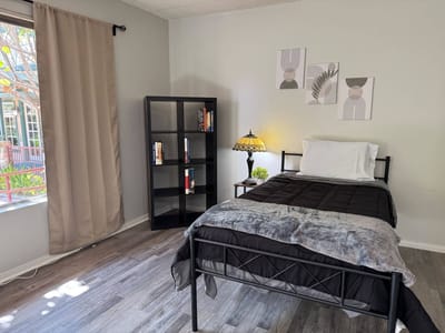 Well-furnished private bedroom with natural light