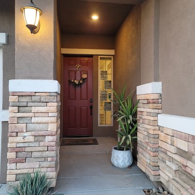 Front entrance of a senior living facility with plants