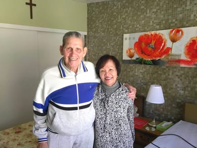 Residents smiling together in a facility room