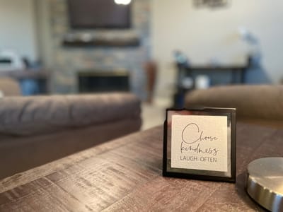 A motivational sign on a table in an interior space