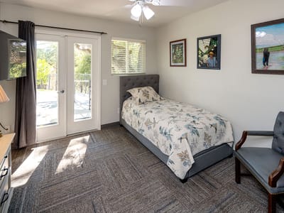 Bright private room with a bed and artwork