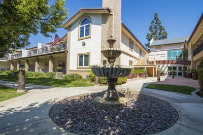 Exterior view of the facility with fountain and landscaping
