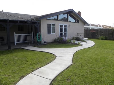 Exterior view of a cottage with a landscaped path